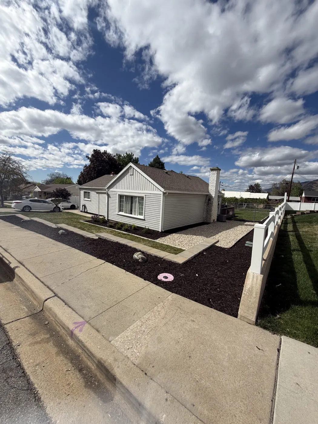 Corner lot finished with mulch beds, rock and new plantings