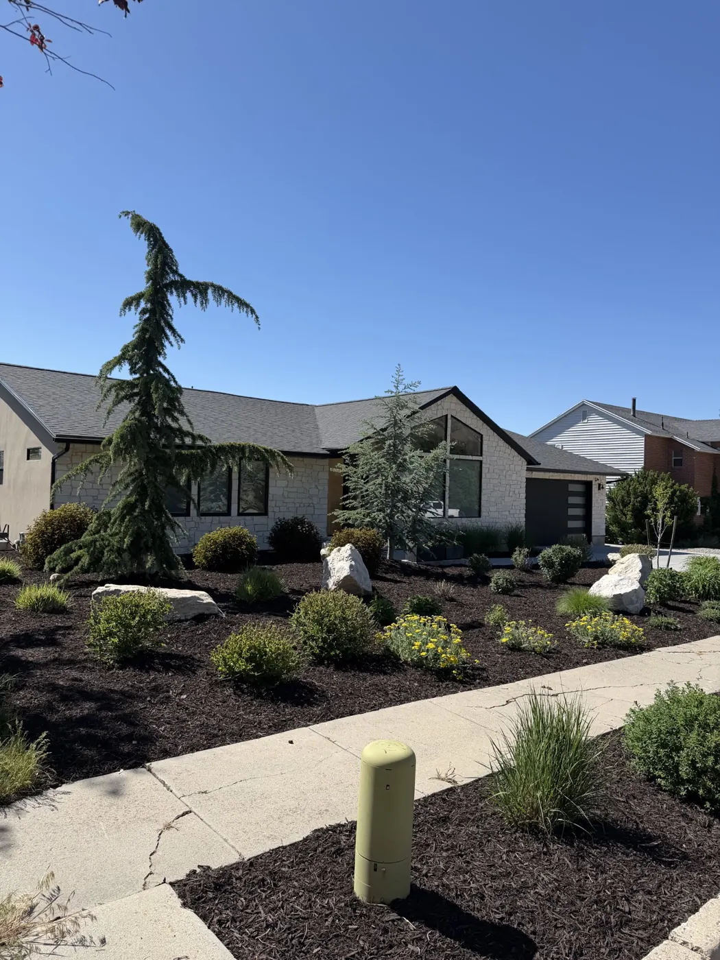 Front yard makeover with boulders, shrubs and fresh mulch