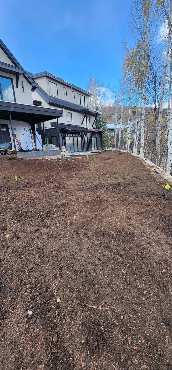 Graded topsoil ready for landscaping at a new mountain home