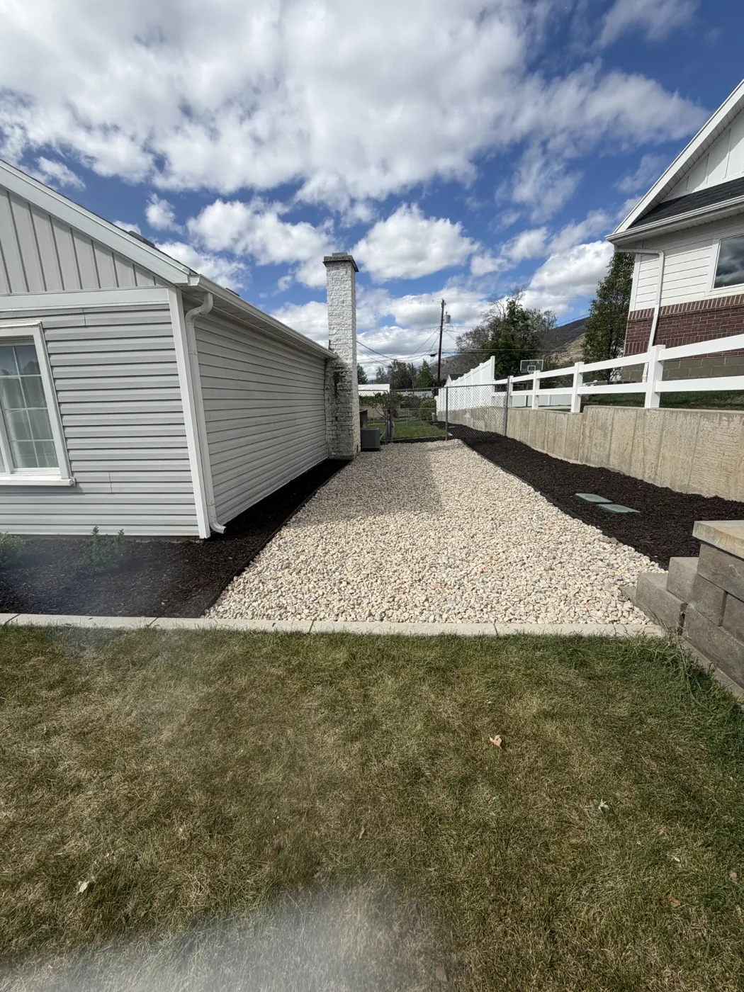 After: Overgrown side yard to rock and mulch