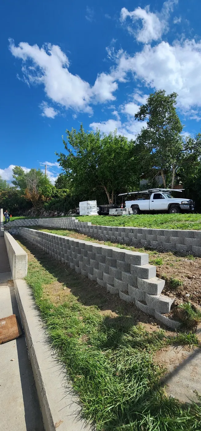 Two-tier block retaining wall with graded terrace
